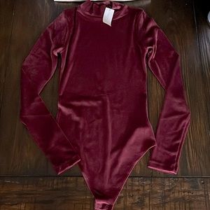 Velvety wine colored body suit.